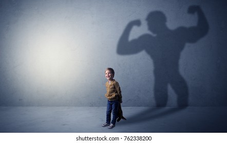 Little waggish boy in an empty room with musclemen shadow behind