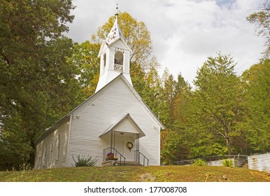 A little white country church in the beginnings of fall colors.