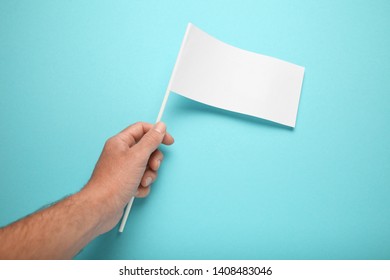 Little White Flag Mockup In Hand For Advertising And Design. Empty Banner, Marketing Information.