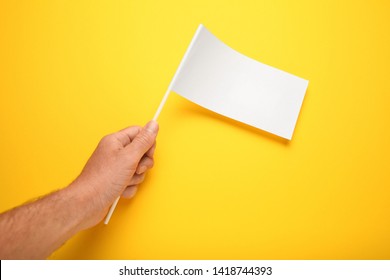 Little White Flag Mockup In Hand For Advertising And Design. Empty Banner, Marketing Information.