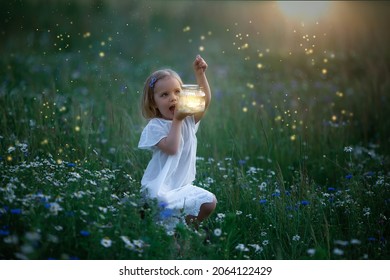 Little white girl sits in an evening glade with fireflies