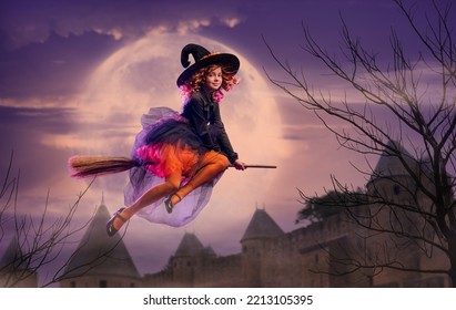 little witch flies on a broomstick on Halloween night against the backdrop of the night sky and a huge moon. Children's costume with a trick. Children are having fun. terrible and terrible holiday.