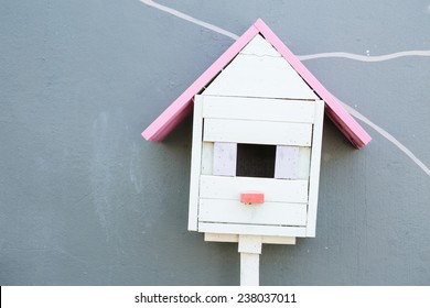 Little Wood Birdhouse On Gray Cement Background