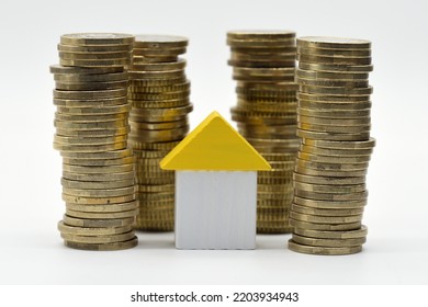 Little Wooden House Surrounded By Piles Of Euro Coins