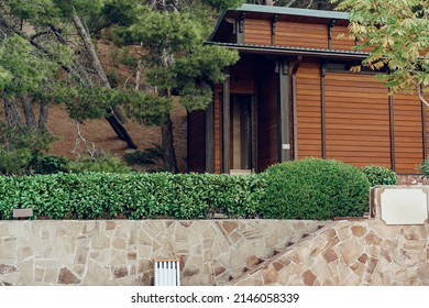 Little Wooden House Surrounded With Trees And Bushes