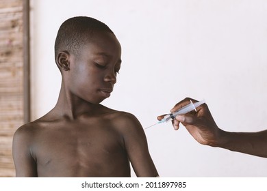 Little Young African Black Boy Getting His Vaccine In A Rural Village In Mali.