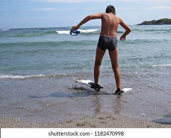 Little Young Boy On A Sand Beach In Swimfin Flippers During Summer Vacation