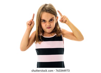 Little Young Girl Is Angry, Mad, Disobedient With Bad Behaviour. Children Making The Act Of Insubordination And Disobedience, Yelling, Flipping Off, Showing The Middle Finger. Act Of Giving The Finger