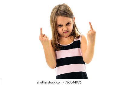 Little Young Girl Is Angry, Mad, Disobedient With Bad Behaviour. Children Making The Act Of Insubordination And Disobedience, Yelling, Flipping Off, Showing The Middle Finger. Act Of Giving The Finger