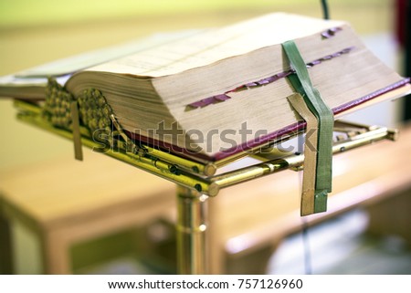 liturgical book - a missal lying on a stand with ribbon tabs