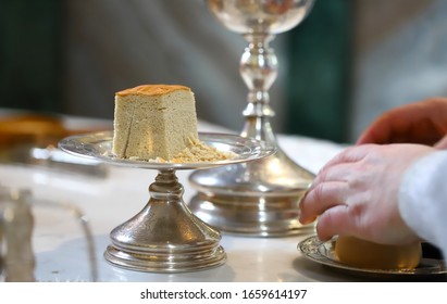 The Liturgical Liturgical Bread Of  Prosphora Prosphorus, Prosper Used During Orthodox Worship. Preparation For Holy Communion. Hands Of The Priest, Icons Placed On The Altar Of The Orthodox Church. 