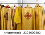 Liturgical clothes, liturgical vestments, robes, hanging on hangers.