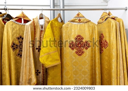 Liturgical clothes, liturgical vestments, robes, hanging on hangers.