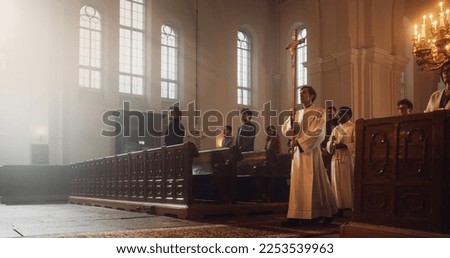 Liturgical in Grand Church: Majestic Procession Of Ministers And Priests Walking with Processional Cross. Congregation Stands In Reverence, Christians Rejoice In Ceremony of Mass in The Lord's Glory