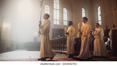 Liturgy in Grand Church: Majestic Procession Of Ministers And Priests Walking with Processional Cross. Congregation Stands In Reverence, Christians Rejoice In Ceremony of Mass
