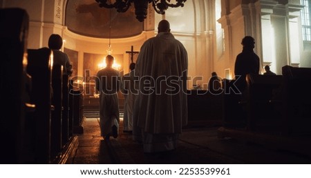 Liturgy in Grand Church: Majestic Procession Of Ministers Walking with Processional Cross to Altar. Congregation Stands In Reverence, Christians Rejoice In Mass Ceremony. Back View
