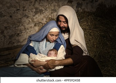Live Christmas nativity scene in an old barn - Reenactment play with authentic costumes. 