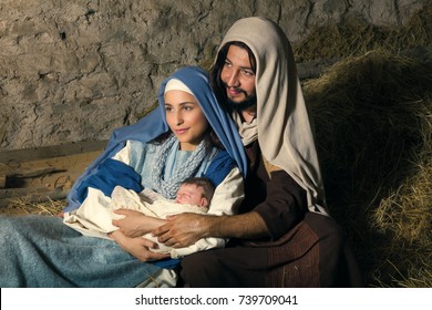 Live Christmas nativity scene in an old barn. Reenactment play with authentic costumes.  The baby is a property released doll.