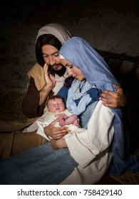 Live Christmas nativity scene in an old barn. Reenactment play with authentic costumes.  The baby is a property released doll.