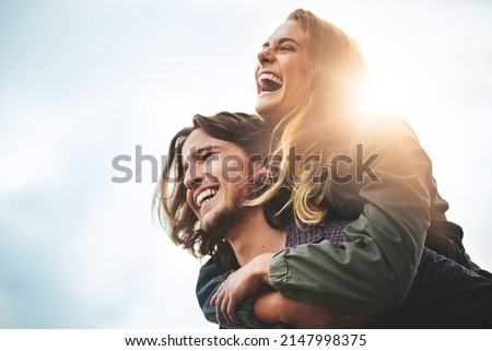 Live, laugh, love. Shot of a happy young couple having fun outside.