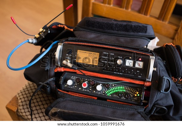Live location set sound recording kit, audio
pack with a recorder and mixer, in record mode, with red REC button
illuminated and green peak meter led lights on, stereo music or
voice recording