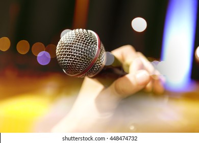 Live music background.Karaoke and microphone concept.Stage lights and singer