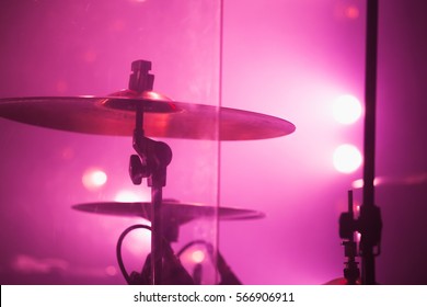 Live Music Photo Background, Rock Drum Set  With Cymbals In Red Stage Lights. Closeup Photo, Soft Selective Focus