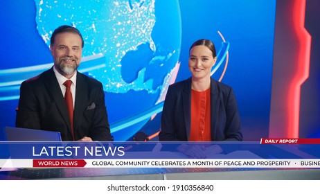 Live News Studio With Beautiful Female And Handsome Man Anchors Start Reporting. TV Broadcasting Channel With Presenters Talking. Inside Mock-up Television Newsroom Set.