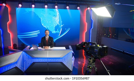 Live News Studio with Professional Male Newscaster Reporting on the Events of the Day. Broadcasting Channel with Presenter, Anchor Talking. Mock-up TV Newsroom Set with News Ticker. High Angle View.
