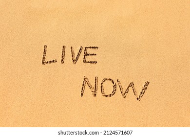 Live now written in the sand beach , motivational symbol  - Powered by Shutterstock