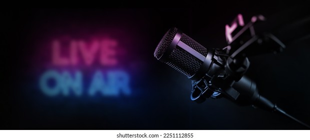 live on air. radio podcast broadcasting studio microphone with neon lights sign. banner with copy space - Shutterstock ID 2251112855