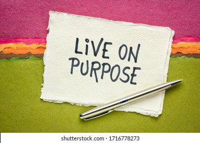 Live on purpose inspiraitonal note - handwriting on a handmade rag paper against abstract landscape, personal devleopment, goals and lifestyle concept