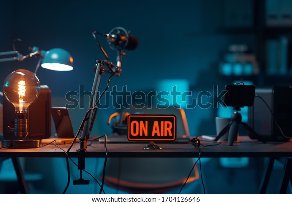 Live online radio studio desk with\
on air sign, entertainment and communication\
concept