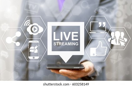 Live streaming social media web network concept. Man offers smart phone with bubble live streaming icon on virtual screen. Broadcast online technology stream video and music. Internet marketing. - Shutterstock ID 603258149