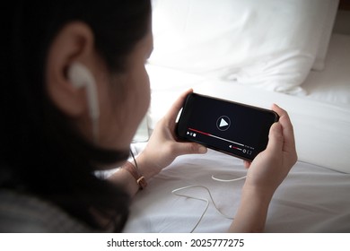 live video content online streaming marketing concept.Woman Hands holding mobile phone and wearing headphone - Shutterstock ID 2025777275
