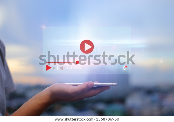 live\
video content online streaming marketing concept.Hands holding\
mobile phone on blurred urban city as\
background