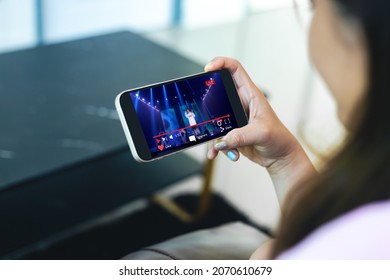 Live video streaming concept.Female hands holding mobile phone - Shutterstock ID 2070610679