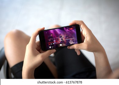 Live video streaming concept.Female hands holding mobile phone
