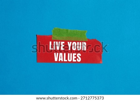 Live your values message written on ripped torn paper background. Conceptual Live your values symbol. Copy space.
