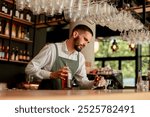 In a lively bar setting, a confident bartender mixes a fresh cocktail, showcasing his expertise with a bottle in hand, ready for the night