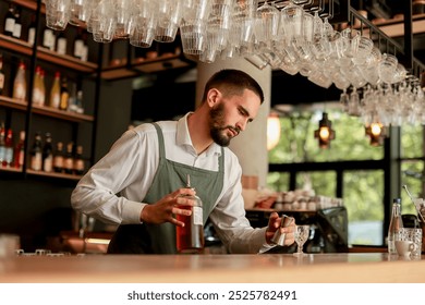 In a lively bar setting, a confident bartender mixes a fresh cocktail, showcasing his expertise with a bottle in hand, ready for the night's rush - Powered by Shutterstock