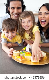 Lively Family Eating Cookies  In The Kitchen