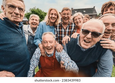 A lively group of senior citizens are caught in a candid moment of pure joy and laughter. Gathered outdoors, their genuine smiles and tight-knit bond radiate warmth and beauty of lifelong friendship. - Powered by Shutterstock