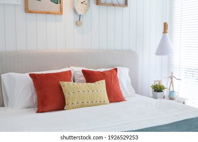 Lively style bedding of red and yellow pillows setting on bed. - Powered by Shutterstock