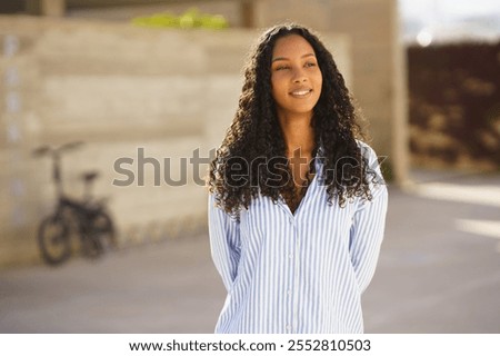 Similar – Image, Stock Photo Confident black woman in front of rustic stone backdrop
