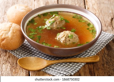 Liver Dumpling soup made Of Beef Liver, Bread, Eggs, And Parsley Cooked In beef Broth Close Up In A Dish On The Table. Horizontal
