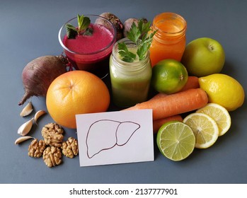 Liver detox juice in a glass jar with ingredients: carrot, beet, lemon, apple, grapefruit, lime, walnut. Fresh smoothie for healthy liver and cleansing or weight loss. Detox diet, nutrition concept.