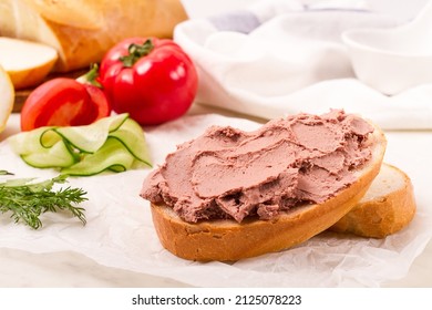 Liver meat pate spread on white bread, on a light background, breakfast, close-up, no people, selective focus, pasticcio, pastete, pate,