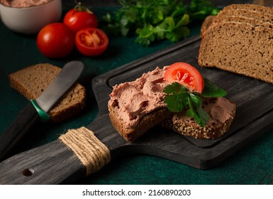 Liver meat pate spread on rye bread, breakfast, close-up, dark background. no people, selective focus, - Shutterstock ID 2160890203
