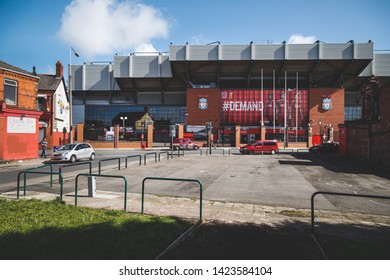 LIVERPOOL, ENGLAND - APRIL 11, 2015: Cars and people in front of Anfield football stadium in Liverpool, England